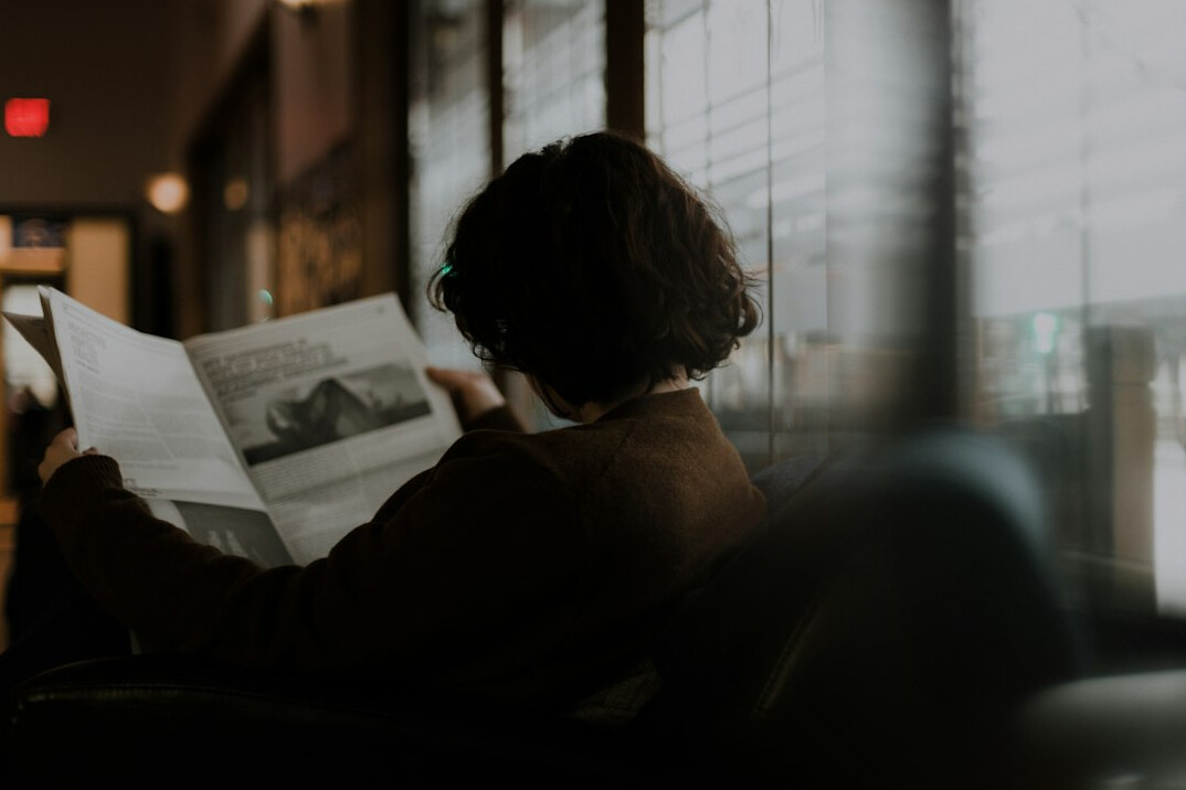 person reading newspaper